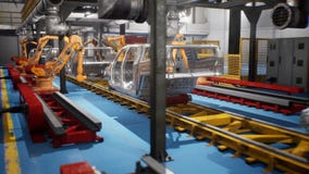 Car welding line of conveyor with frameworks of unfinished cars and robots welders