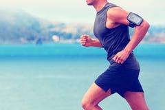 Cardio runner running listening smartphone music stock photography Cardio runner running listening smartphone music stock photography