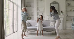 Carefree active multi generation women family dancing at home