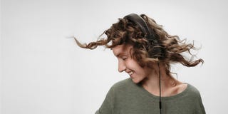 Carefree cheerful young curly woman listen favourite music stock images Carefree cheerful young curly woman listen favourite music stock images