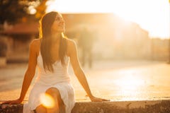 Carefree woman enjoying in nature, beautiful red sunset sunshine. Finding inner peace. Spiritual healing lifestyle. Enjoying peace