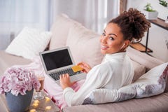 Happy african girl with credit card shopping in internet stock photos Happy african girl with credit card shopping in internet stock photos