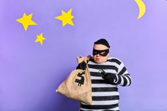 Careful prisoner with a sack trying to hide from police royalty free stock images Careful prisoner with a sack trying to hide from police royalty free stock images