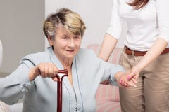 Caregiver supporting senior woman with walking stick stock photos Caregiver supporting senior woman with walking stick stock photos