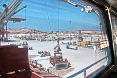 Cargo terminal for loading of gypsum cargo by ship cranes to bulk carrier. Port of Salalah, Oman. stock image Cargo terminal for loading of gypsum cargo by ship cranes to bulk carrier. Port of Salalah, Oman. stock image