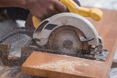 Carpenter use electric saw to sawing wood Stock Photos Carpenter use electric saw to sawing wood Stock Photos