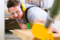 Carpenter using electric saw in carpentry royalty free stock images Carpenter using electric saw in carpentry royalty free stock images