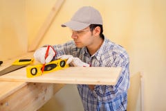 Carpenter at work using a bubble level royalty free stock photos Carpenter at work using a bubble level royalty free stock photos