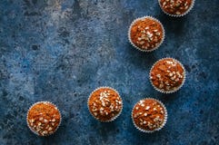 Carrot cake muffins with nuts, raisins and oats on a blue stone royalty free stock photo Carrot cake muffins with nuts, raisins and oats on a blue stone royalty free stock photo