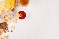 Casse-croûte d'or croustillants sur la sauce à papier de métier, à nachos de triangles, blonde à bière, rouge et jaune dans la cu photos libres de droits Casse-croûte d'or croustillants sur la sauce à papier de métier, à nachos de triangles, blonde à bière, rouge et jaune dans la cu photos libres de droits