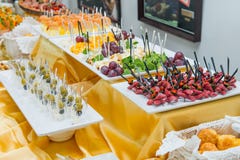 Catering table with dishes and snacks on the business event in the hotel hall. Service at business meeting, party, weddings. Selec Stock Photography Catering table with dishes and snacks on the business event in the hotel hall. Service at business meeting, party, weddings. Selec Stock Photography