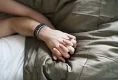 Caucasian couple lying on bed together Royalty Free Stock Photos Caucasian couple lying on bed together Royalty Free Stock Photos