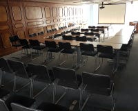 Classroom with chairs black color and slide projector stock photos Classroom with chairs black color and slide projector stock photos