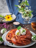 Challah Bread With Raisins, Cardamom And Vanilla On A White Dish. Near Boiled Eggs And A Cup Of Tea, A Branch Of Blooming Cherry. Royalty Free Stock Photography Challah Bread With Raisins, Cardamom And Vanilla On A White Dish. Near Boiled Eggs And A Cup Of Tea, A Branch Of Blooming Cherry. Royalty Free Stock Photography