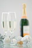 Champagne For Christmas. Two champagne glasses and bottle of champagne in background with Christmas decorations stock images Champagne For Christmas. Two champagne glasses and bottle of champagne in background with Christmas decorations stock images