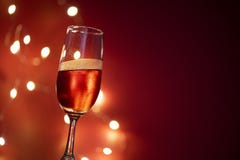 Champagne glass on table against blurred lights background - perspective of crystal clear wine glass for night party on the stock photo Champagne glass on table against blurred lights background - perspective of crystal clear wine glass for night party on the stock photo