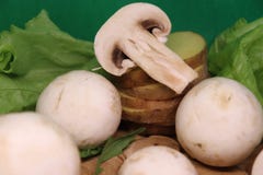 Champignons on a green background, with potato wedges and a beautiful salad royalty free stock photography Champignons on a green background, with potato wedges and a beautiful salad royalty free stock photography