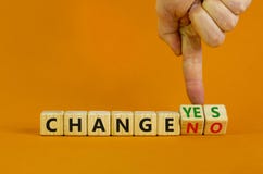 Change yes or no symbol. Businessman turns cubes and changes words `change no` to `change yes` or vice versa. Beautiful orange