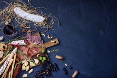 Charcuterie snacks on wood background. Salami and cheese served royalty free stock photography Charcuterie snacks on wood background. Salami and cheese served royalty free stock photography