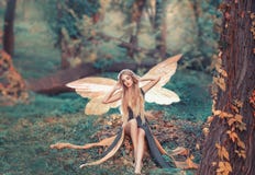 Charming fairy woke up in forest, sweetly smacks after sleeping, cue girl with blond hair, eyes closed in long green stock photo Charming fairy woke up in forest, sweetly smacks after sleeping, cue girl with blond hair, eyes closed in long green stock photo