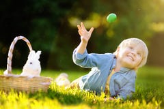 Charming little boy hunting for easter egg in spring park on Easter day Royalty Free Stock Photo Charming little boy hunting for easter egg in spring park on Easter day Royalty Free Stock Photo