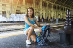 Cheerful Asia woman packing bag backpack for go to travel trip a stock images Cheerful Asia woman packing bag backpack for go to travel trip a stock images