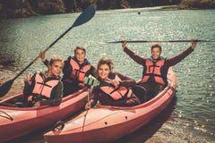 Cheerful best friends taking selfie in kayaks on a beach. royalty free stock image Cheerful best friends taking selfie in kayaks on a beach. royalty free stock image