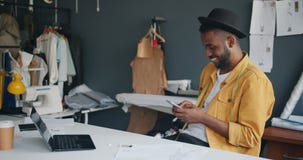 Cheerful designer enjoying communication with smartphone touching screen stock video footage Cheerful designer enjoying communication with smartphone touching screen stock video footage
