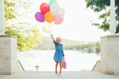Cheerful Girl Holding Colorful Balloons And Childish Suitcase Royalty Free Stock Images