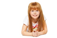 A cheerful little girl with red hair is lying ; isolated on the white Stock Photography A cheerful little girl with red hair is lying ; isolated on the white Stock Photography