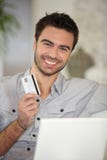 Cheerful man with credit card stock photography Cheerful man with credit card stock photography