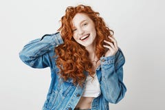 Cheerful redhead girl smiling laughing looking at camera over white background. Copy space. royalty free stock photography Cheerful redhead girl smiling laughing looking at camera over white background. Copy space. royalty free stock photography
