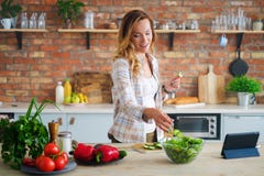Cheerful woman cooking on modern kitchen