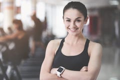 Cheerful woman folding arms in gym. royalty free stock photos Cheerful woman folding arms in gym. royalty free stock photos
