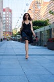 Cheerful Young Woman Walks Barefoot Stock Images