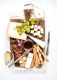 Cheese appetizer set. Various types of cheese, honey, grapes, pear, nuts and bread grissini sticks on rustic wooden stock photo Cheese appetizer set. Various types of cheese, honey, grapes, pear, nuts and bread grissini sticks on rustic wooden stock photo