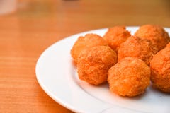 Cheese balls, Breaded mozzarella cheese balls with tomato in white dish on wood blackground stock photos Cheese balls, Breaded mozzarella cheese balls with tomato in white dish on wood blackground stock photos
