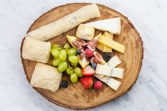 Cheese plate with bread grapes and strawberries royalty free stock photos Cheese plate with bread grapes and strawberries royalty free stock photos