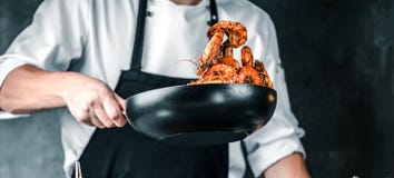 Chef-kok het koken tijgergarnalen in de wok in de restaurantkeuken royalty-vrije stock foto Chef-kok het koken tijgergarnalen in de wok in de restaurantkeuken royalty-vrije stock foto