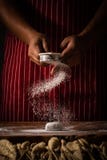Chef spreading flour on bakery prepare for baking. Cook showing royalty free stock photography Chef spreading flour on bakery prepare for baking. Cook showing royalty free stock photography