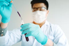 Chemist scientist conducts experiments by synthesising compounds stock photo Chemist scientist conducts experiments by synthesising compounds stock photo