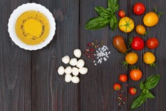 Cherry tomatoes, mozzarella, basil leaves, spices and olive oil from above. Italian caprese salad recipe ingredients Royalty Free Stock Photos Cherry tomatoes, mozzarella, basil leaves, spices and olive oil from above. Italian caprese salad recipe ingredients Royalty Free Stock Photos