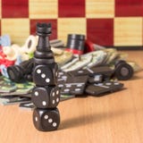 Chess rook stands on dice on a blurred chessboard background stock images Chess rook stands on dice on a blurred chessboard background stock images