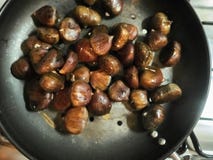 Chestnuts placed in the pan stock photos Chestnuts placed in the pan stock photos