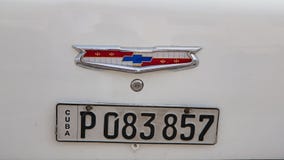 Chevrolet logo on antique cuban car, Havana, Cuba, license plate on white classic cuban car
