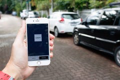 CHIANG MAI THAILAND-SEP 02,2016: En kvinnahand som rymmer den Uber applien royaltyfri bild CHIANG MAI THAILAND-SEP 02,2016: En kvinnahand som rymmer den Uber applien royaltyfri bild