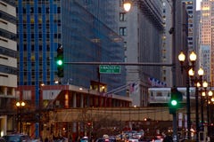 Commuters travel on LaSalle Street while Chicago`s Elevated `el` Train passes through the Loop at Sunset Royalty Free Stock Images Commuters travel on LaSalle Street while Chicago`s Elevated `el` Train passes through the Loop at Sunset Royalty Free Stock Images