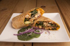 Chicken wrap on a wooden table stock photography Chicken wrap on a wooden table stock photography