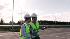 Chief Engineer And Director Of Project Is A Man And Woman In Green Vests stock video Chief Engineer And Director Of Project Is A Man And Woman In Green Vests stock video