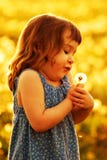 Child Blowing Dandelion At Sunset Royalty Free Stock Photo